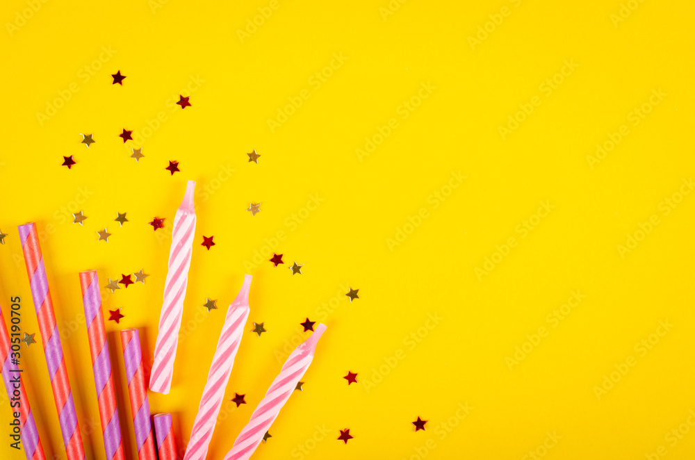 Colored drinking straws and air balloons composition on yellow background, party and celebration decoration.