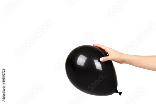 Hand with black inflateble balloon, party event decoration, glossy ball. photo