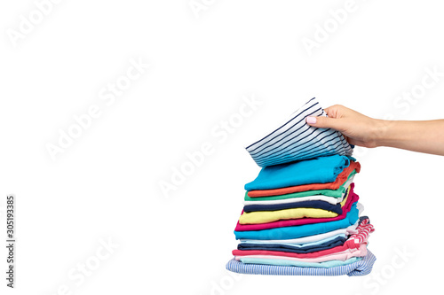 Hand with stack of clothes, fresh laundry textile. Isolated.