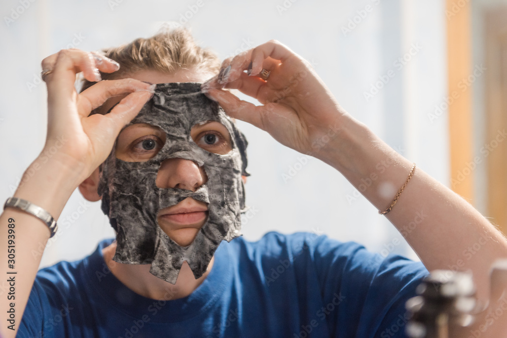 Fototapeta premium facial cleansing mask. Girl Wearing A Face Mask. lady's beauty. face cleaning at home. facial at home. foamy face mask.