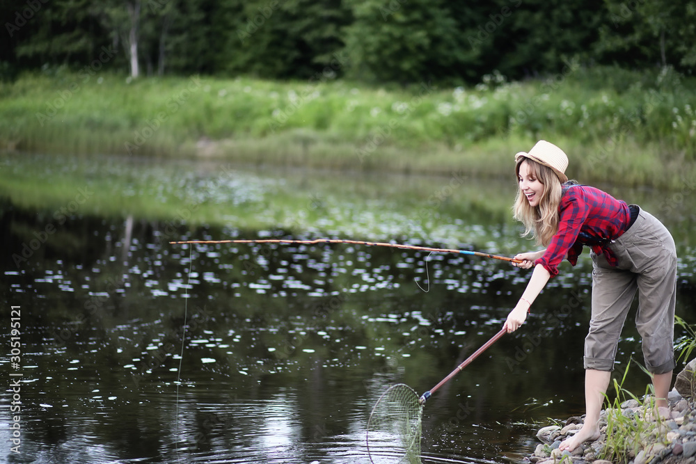 Girl by the river with a fishing rod Girl by the river with a fishing rod