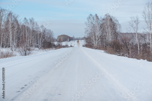 Winter road. Ride through the winter forest. Snow fell in the forest. Road through the snow.