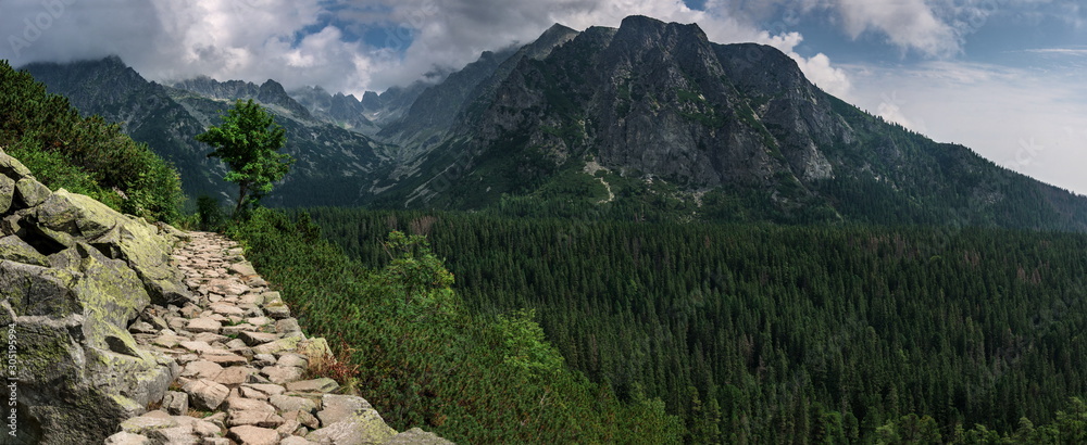 Obraz premium Panoramic view of mountains stone trail to The Popradske pleso lake in High Tatras National Park. Slovakia. Europe. Mountain hiking. Concept of journey, travel lifestyle, harmony with nature.