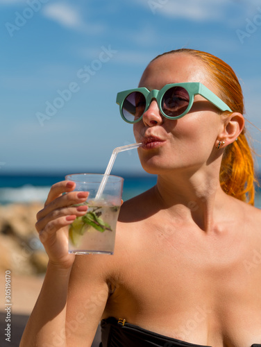 Young woman with mojito