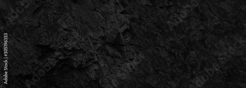 Black stone background. Dark banner with beautiful rock texture. Copy space.