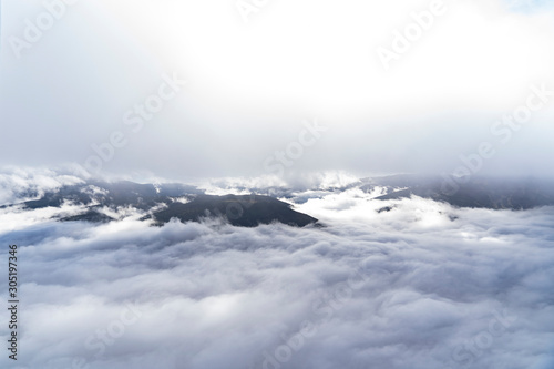 views of the mountains, clouds and fog below during a hot air balloon flight in La Cerdanya, Catalonia © ikuday