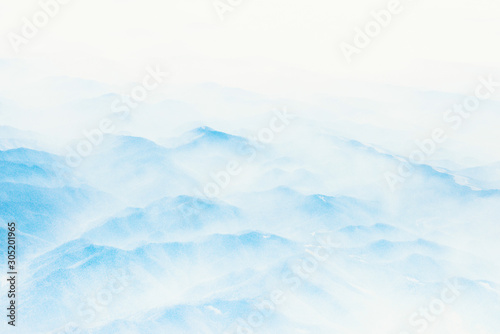 Aerial view of distant mountains layers range in morning mist. Meditation and zen landscape. © vovik_mar