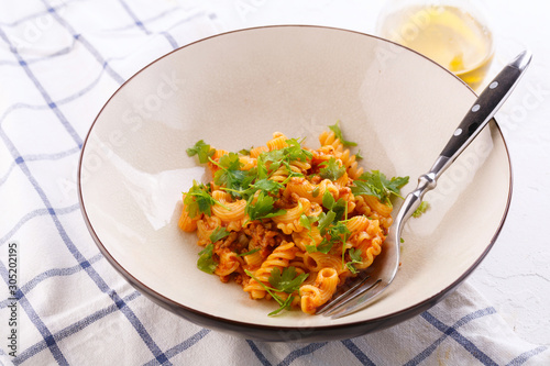 traditional pasta with meat and herbs in a beige plate