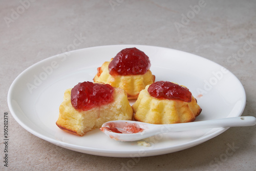 A portion of cottage cheese casserole with strawberry jam and peaches