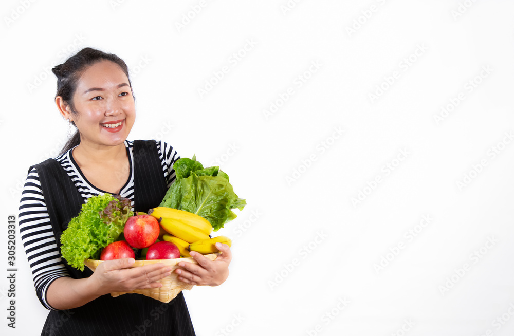 The image of a beautiful Asian woman holding healthy fruits and vegetables for diet in the white background. The image of a beautiful Asian woman holding healthy fruits and vegetables for diet in the white background.