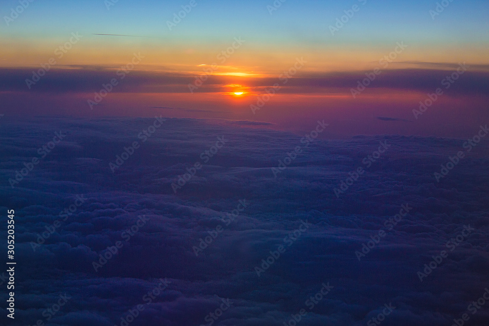 Fototapeta premium Beautiful colorful sunset on the sky above the Tunisia, view from the airplane