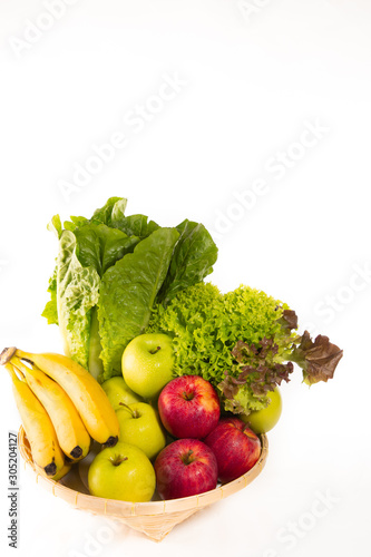 Fototapeta Naklejka Na Ścianę i Meble -  Bio-organic salad vegetables, apples, bananas in a basket. Good for health. Diet in the white background.