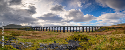 Panorama of Ribblehead Viaduct, which carries the Settle to Carlisle Railway across Batty Moss spanning 400 m and 32 m above the valley floor photo