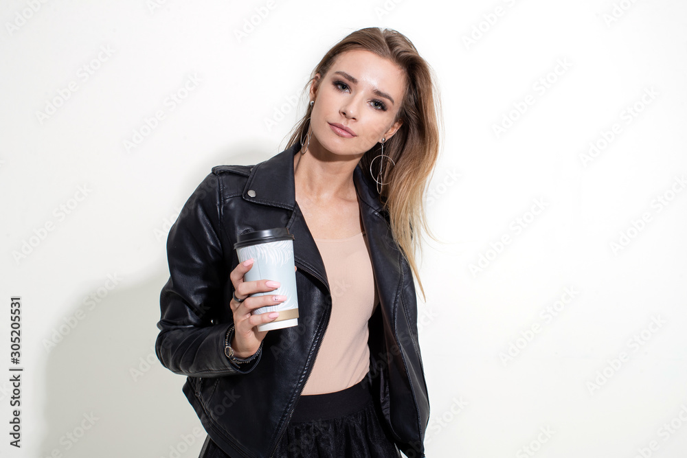 Girl shows plastic coffee cup on white background Girl shows plastic coffee cup on white background