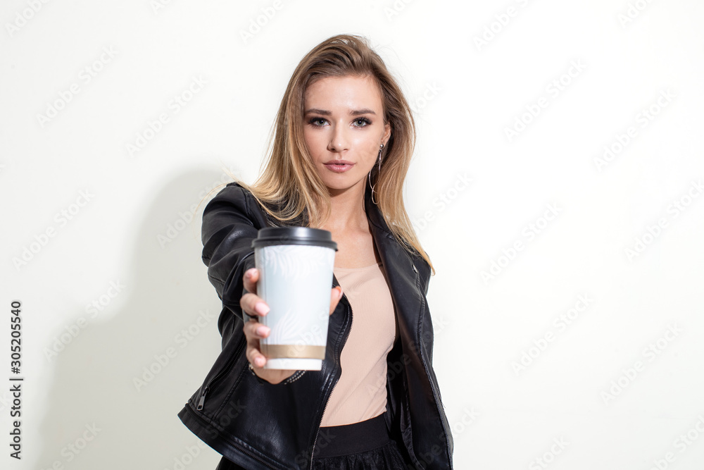 Girl shows plastic coffee cup on white background Girl shows plastic coffee cup on white background