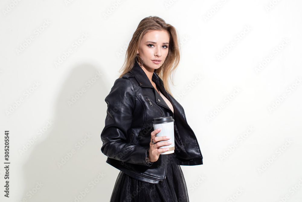 Girl shows plastic coffee cup on white background Girl shows plastic coffee cup on white background