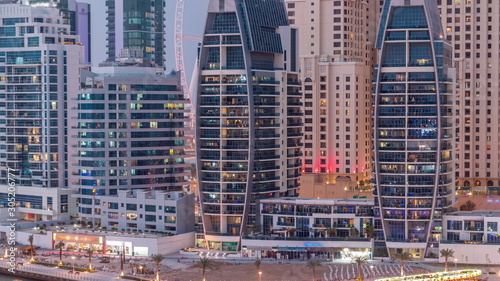 Dubai Marina skyscrapers, port with luxury yachts and Marina promenade aerial day to night timelapse, Dubai, United Arab Emirates © neiezhmakov