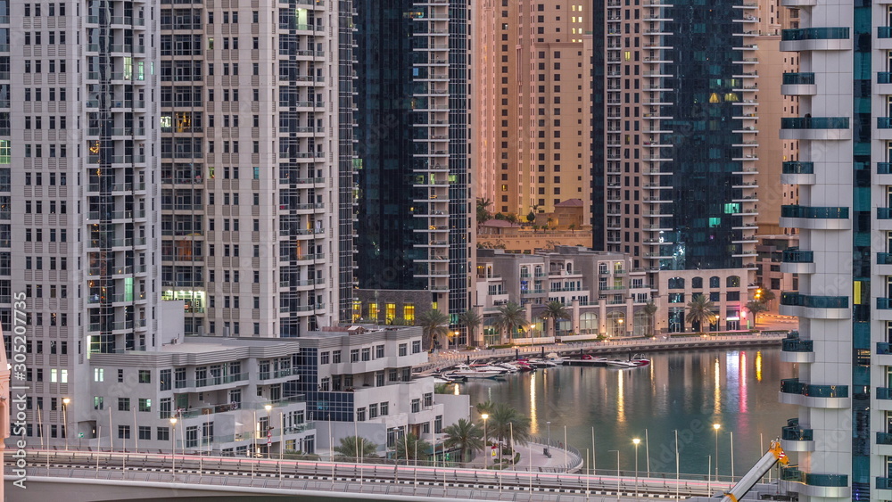 Dubai Marina skyscrapers and promenade aerial night to day timelapse, Dubai, United Arab Emirates