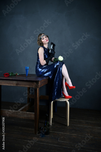 girl in a blue evening dress with a gun
