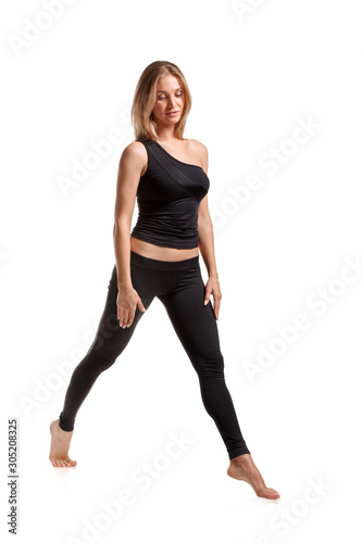 Young beautiful fitness woman posing on white background