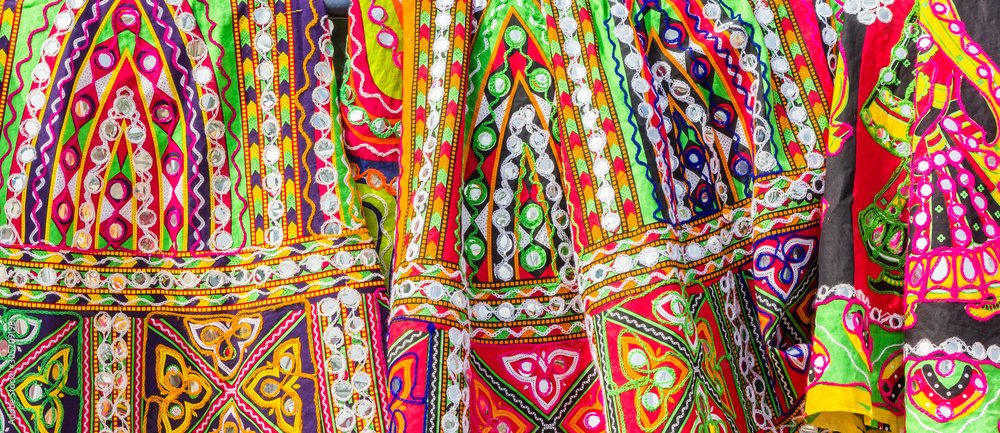 Panorama of colorful traditional indian fabric at a street market in Jaipur, India