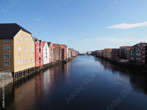 Scenic view to colorful buildings at Nidelva river in european Trondheim city at Trondelag district in Norway