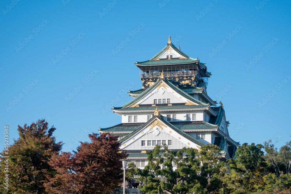 Osaka Castle in Osaka with autumn leaves. Japan Travel Concept Osaka Castle in Osaka with autumn leaves. Japan Travel Concept