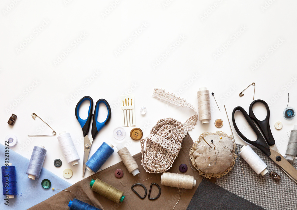 Flat lay composition with sewing accessories: threads, fabrics, scissors,  buttons, needles, pins and other sewing tools on a white background. Top  view, copy space, mock up. Stock Photo | Adobe Stock