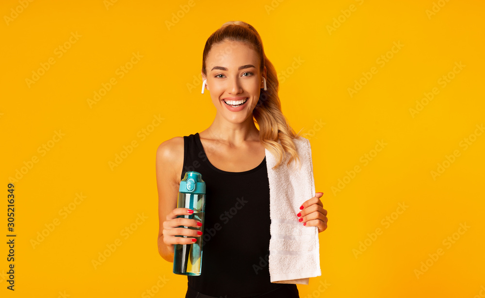 Lady Listening To Music Holding Water And Towel, Yellow Background - obrazy, fototapety, plakaty 