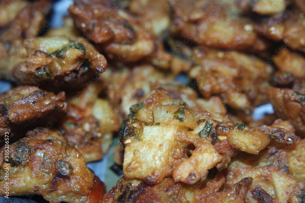 close-up view with selective focus of crispy basin pakora/pakoda or patties close-up view with selective focus of crispy basin pakora/pakoda or patties
