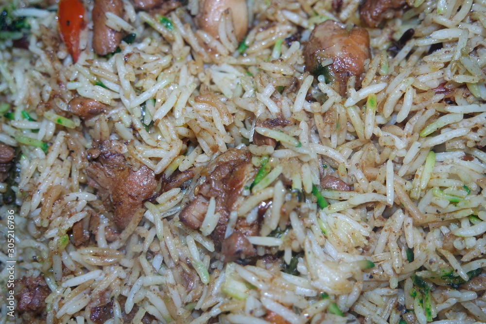 Cooked white Basmati rice pulao or biryani with chicken meat