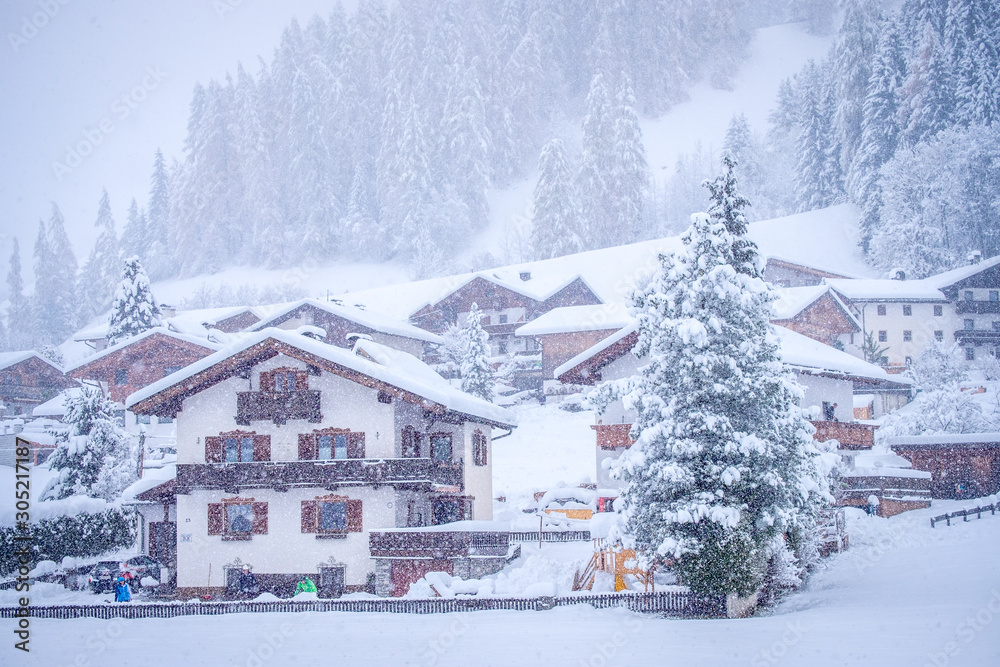 Winter landscape in the town of Neustift in the Stubai Valley in Austria. Tyrolean house amid heavy snow and fir trees Winter landscape in the town of Neustift in the Stubai Valley in Austria. Tyrolean house amid heavy snow and fir trees
