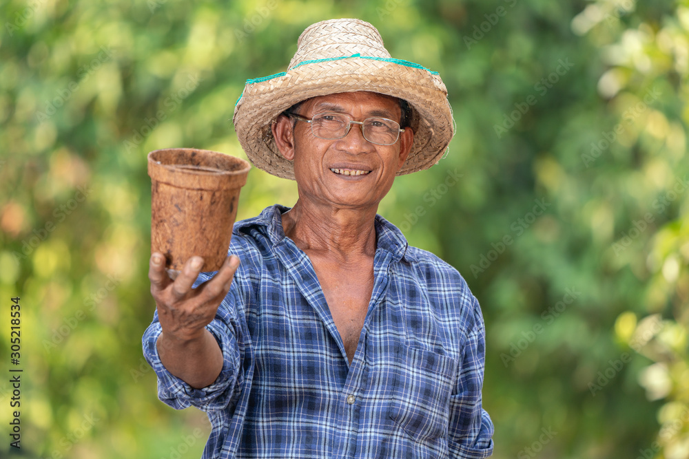 Fototapeta premium Asian farmer agriculture holding pot.