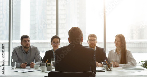 HR manager interviewing man, candidate sitting back to camera