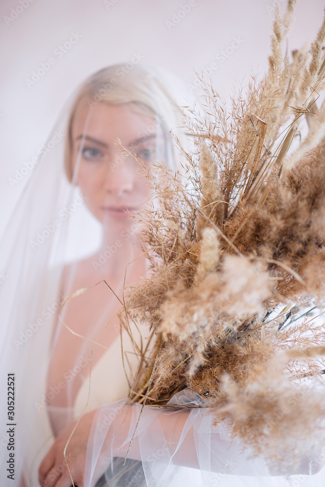 Beautiful and courageous bride with an unusual beech and veil. Portrait of a beautiful bride with short hair. Beautiful and courageous bride with an unusual beech and veil. Portrait of a beautiful bride with short hair.