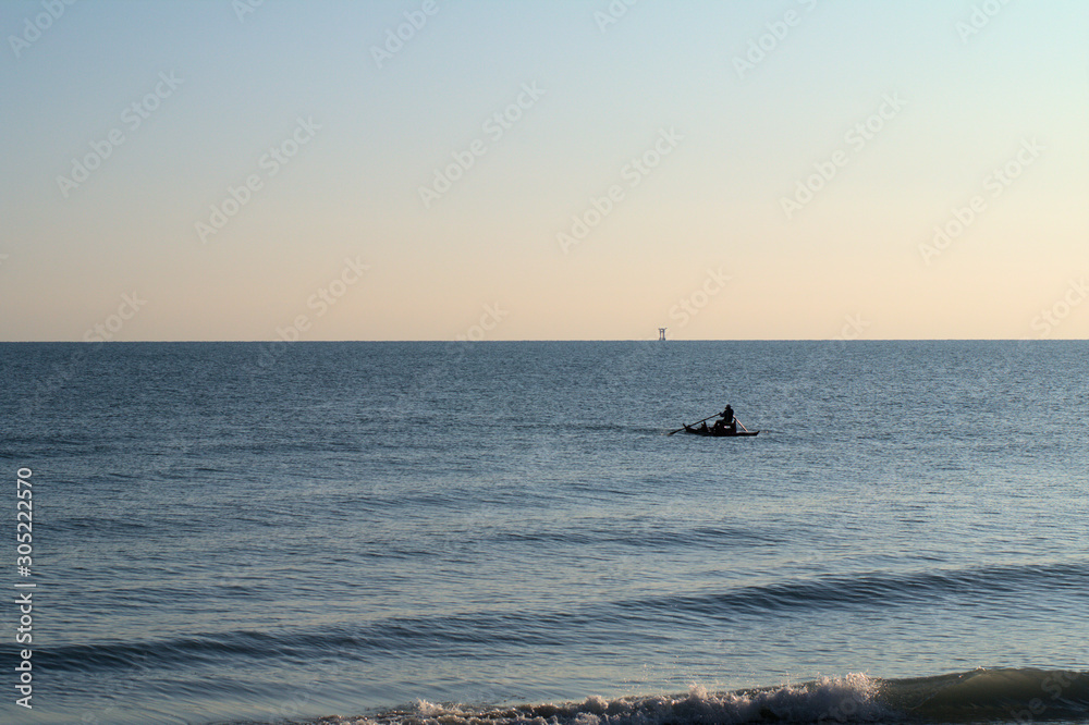 fishing at sunset,sea,horizon,water,coast,view,sky