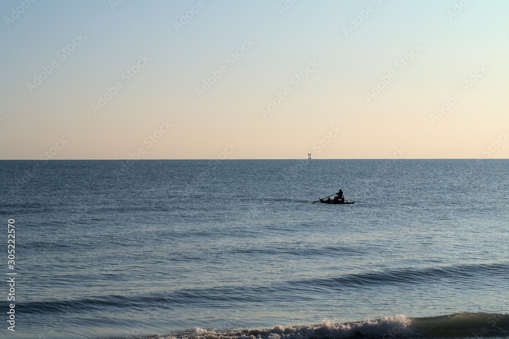 Fototapeta premium fishing at sunset,sea,horizon,water,coast,view,sky