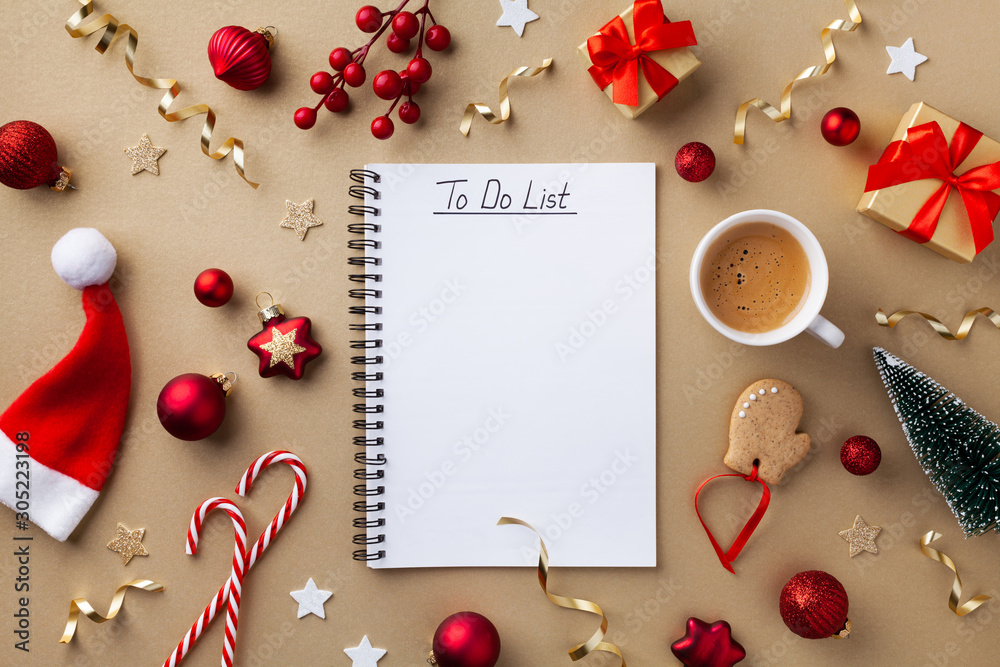 Cup of coffee, holiday decorations and notebook with to do list on golden background top view, Christmas planning concept. Flat lay style. - obrazy, fototapety, plakaty 