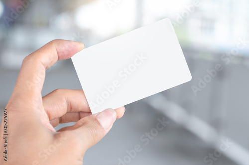 hand holding empty blank white business card mock up design text for advertisement branding.
