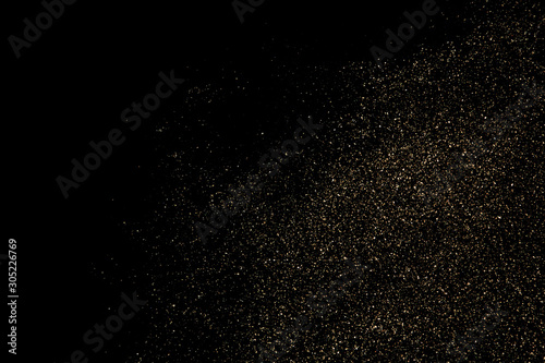 Gold glitter particles texture. Golden dust isolated on black background