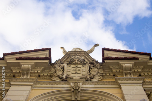 Details of a historic building facade in Rio de Janeiro with Portuguese symbols