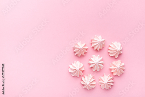 Composition of pink and white meringues on a pink paper background. Pastel. © Galyna Chyzh