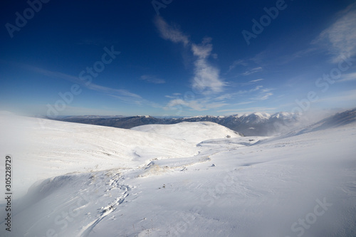 Winter snowy view in Caucasus mountains cold blue clear sky