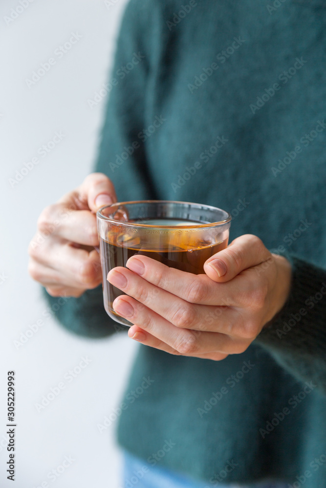 Glass tea cup in hands Glass tea cup in hands