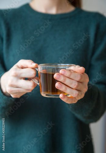 Close up hands holding tea cup