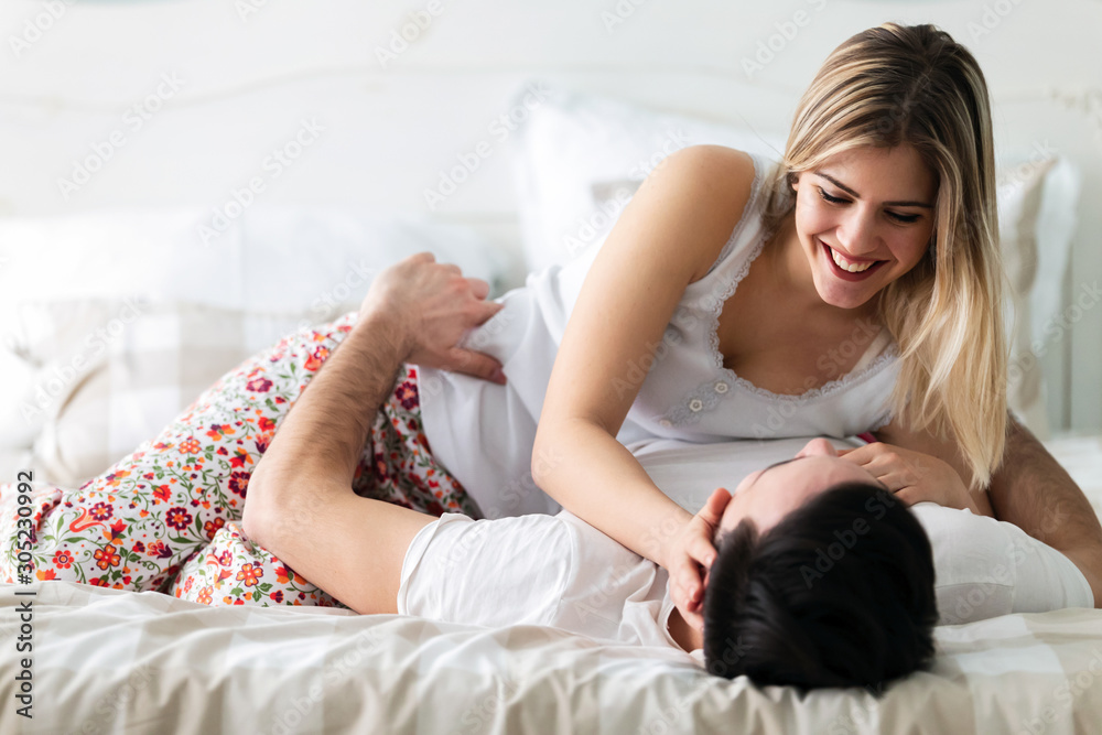 Young couple having romantic time in bedroom Young couple having romantic time in bedroom