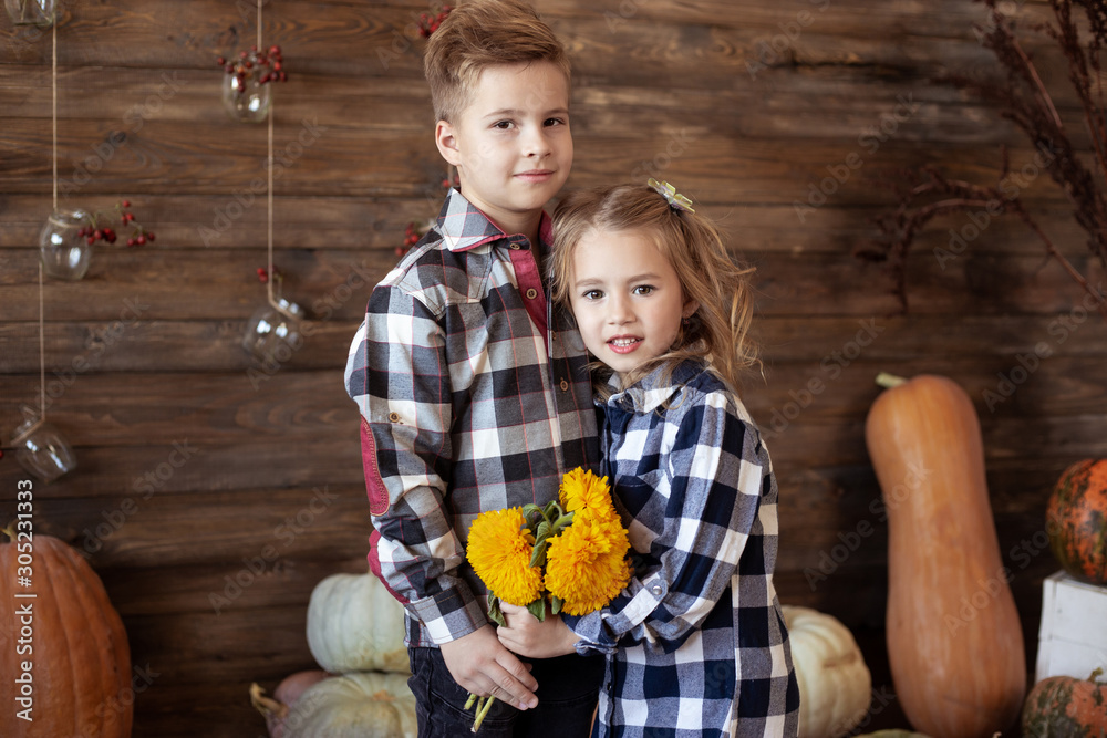 Fototapeta premium Boy and girl with bouquet of yellow flowers. love concept