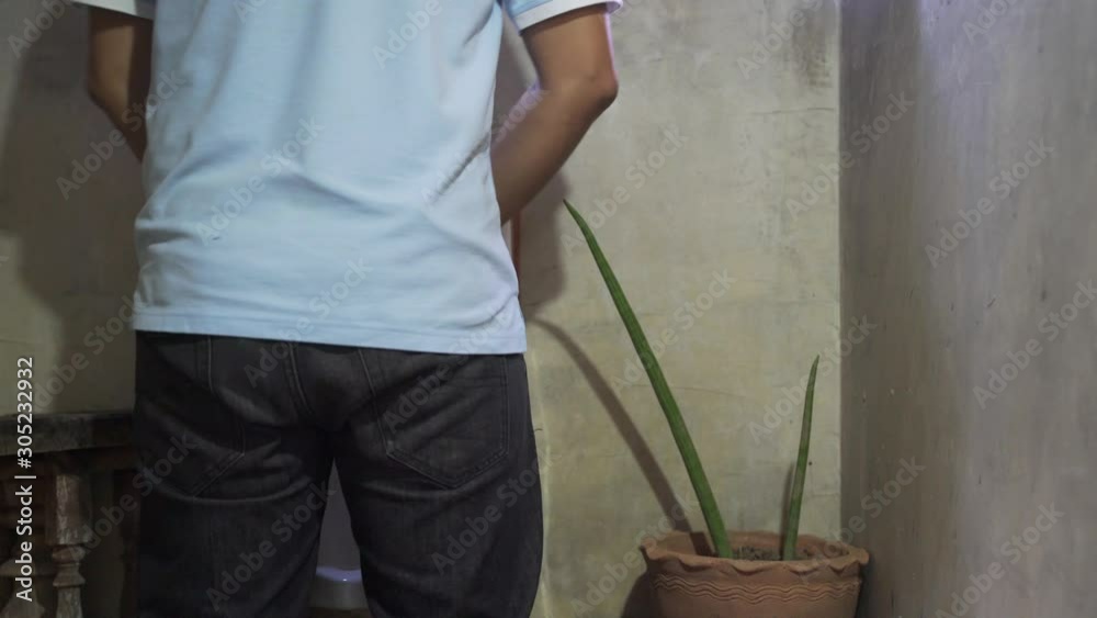 A man peeing by using urinal in men public toilet Stock ビデオ | Adobe Stock