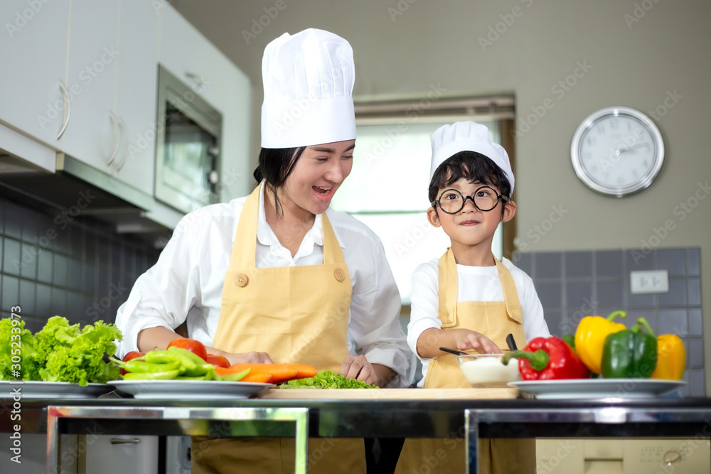 Happy family Asian woman young mother with son boy cooking healthy salad for the first time. first lesson and healthy lifestyle concept. Happy family Asian woman young mother with son boy cooking healthy salad for the first time. first lesson and healthy lifestyle concept.