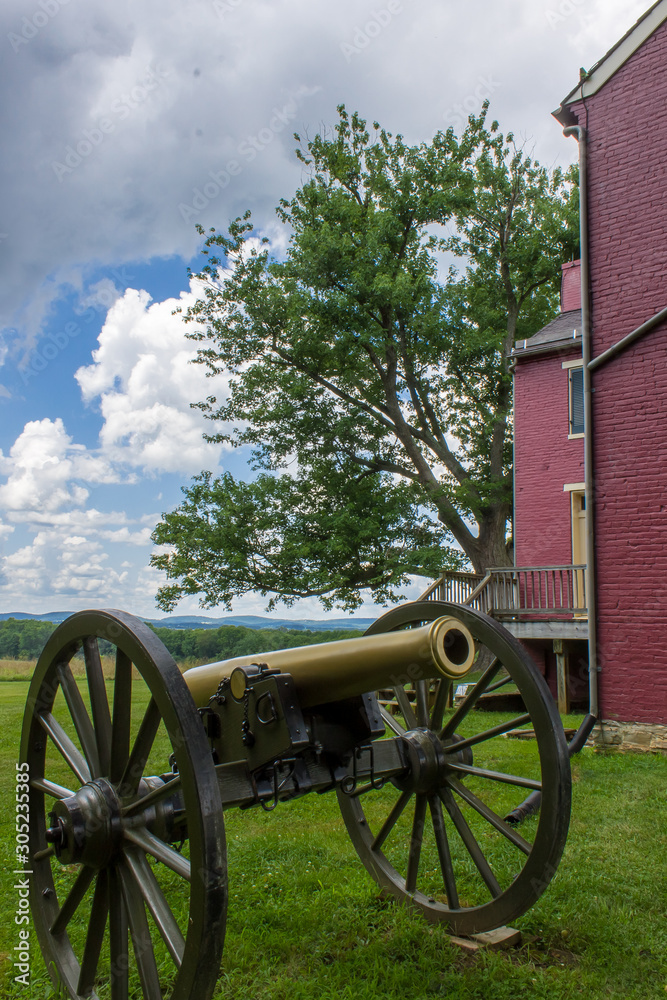A Civil War artillery piece at  Monocacy Battlefield next to historic Worthington Farm part of the National Park Service